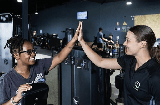 Members high-fiving after workout