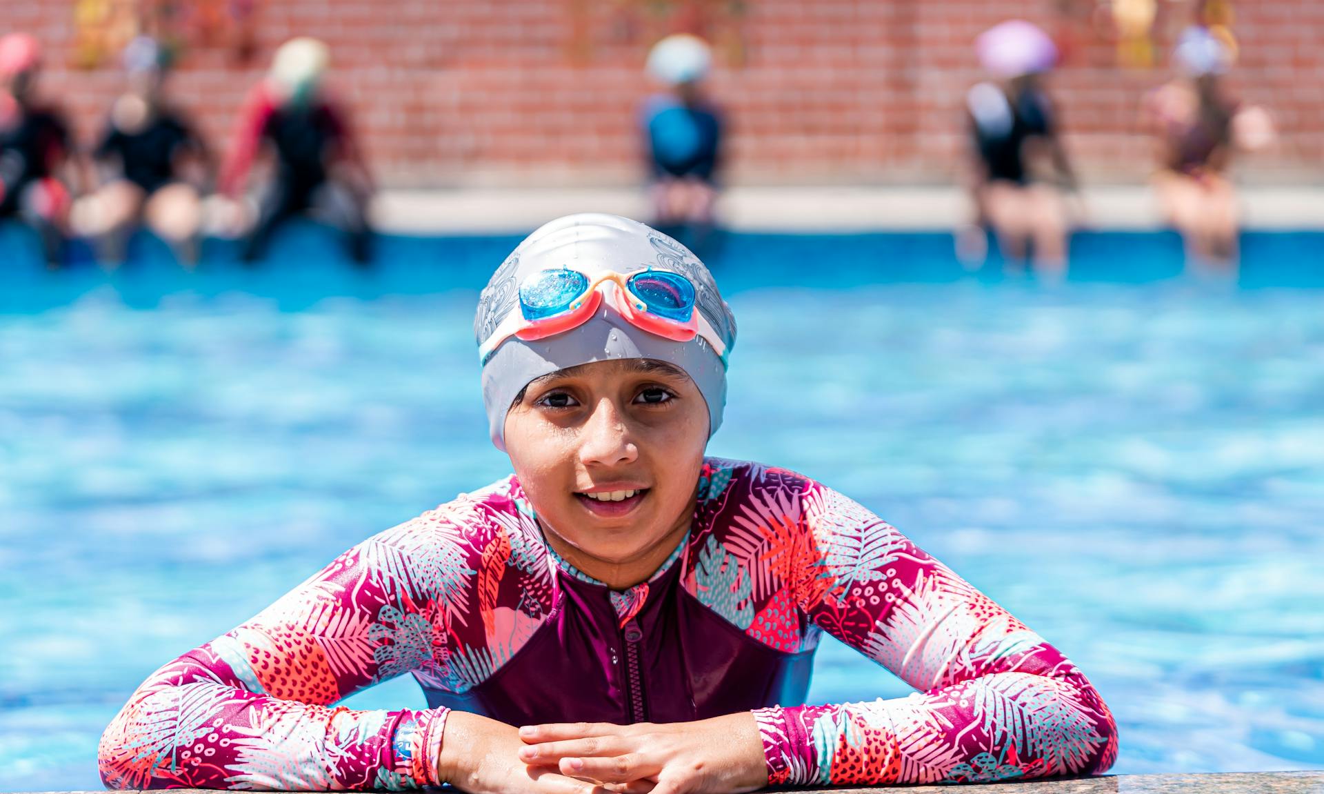 Child learning to swim with instructor